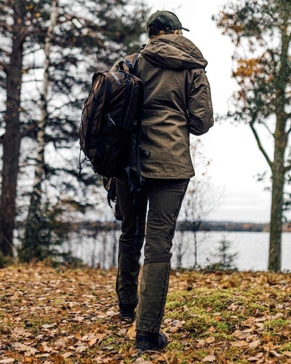 Mid Green Dark Anthracite Coloured Pinewood Womens Finnveden Hybrid Trousers on outdoor background 