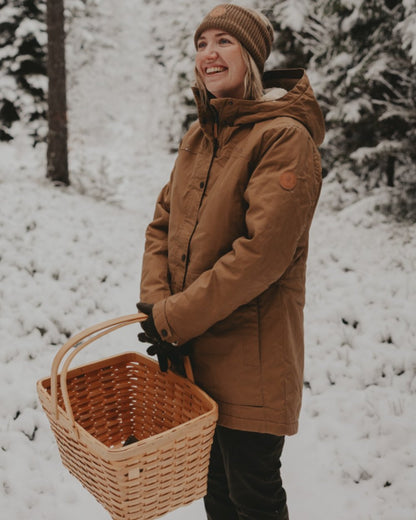 Dark Sandstone coloured Pinewood Womens Finnveden Winter Jacket on snow background 