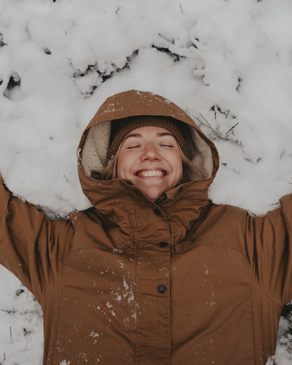Dark Sandstone coloured Pinewood Womens Finnveden Winter Jacket on snow background 
