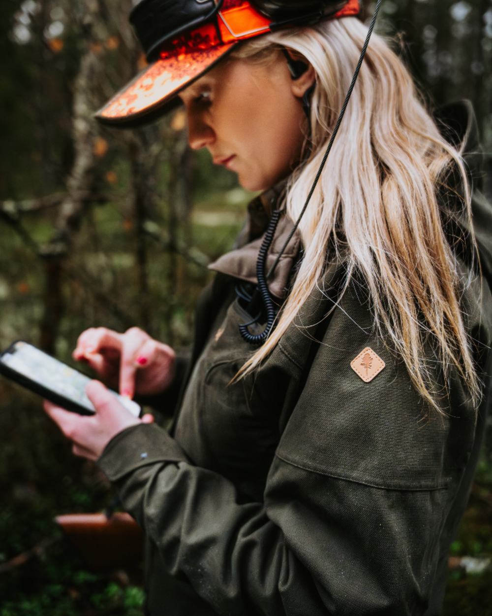 Dark Moss Green coloured Pinewood Womens Furudal Expert 2L Hunting Jacket on forest background 