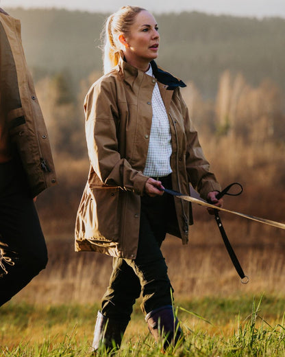 Dark Sandstone coloured Pinewood Womens Nydala Classic 2L Jacket on  forest background 