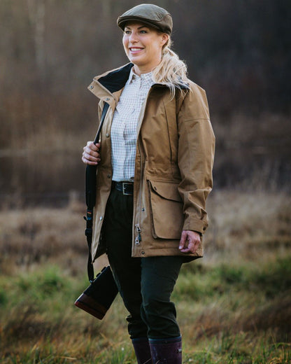 Dark Sandstone coloured Pinewood Womens Nydala Classic 2L Jacket on  forest background 