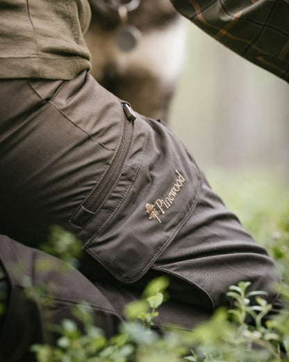 Dark Olive coloured Pinewood Womens Pro InsectSafe Trousers on forest background 