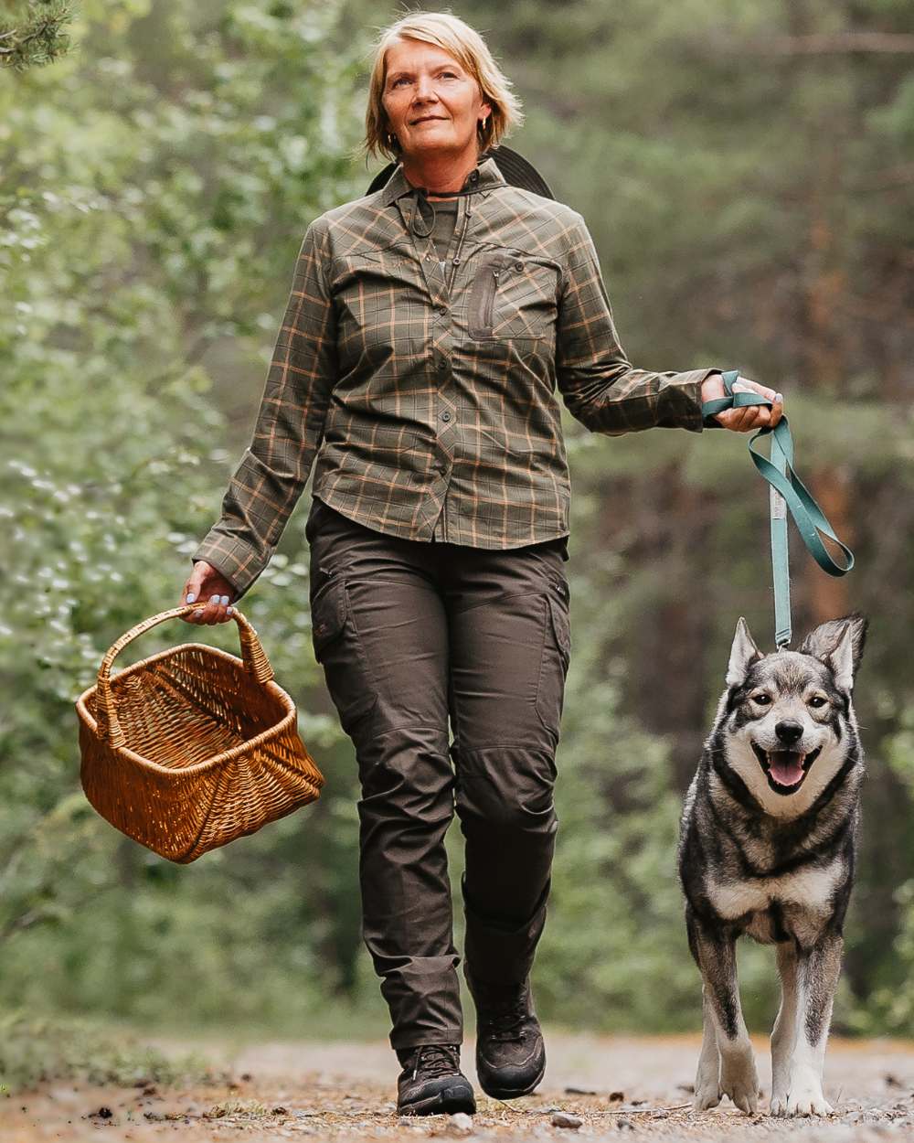 Dark Olive coloured Pinewood Womens Pro InsectSafe Trousers on forest background 