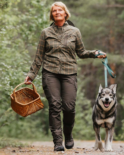 Dark Olive coloured Pinewood Womens Pro InsectSafe Trousers on forest background 