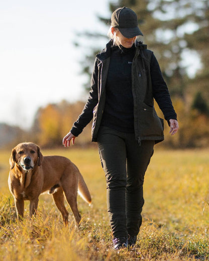 Moss Green Coloured Pinewood Womens Wilda Stretch Shell Trousers on outdoor background 