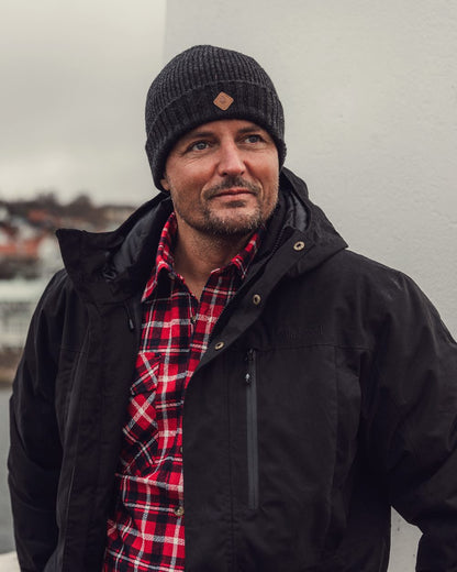 Dark Anthracite Mel Coloured Pinewood Wool Knitted Hat on outdoor background 