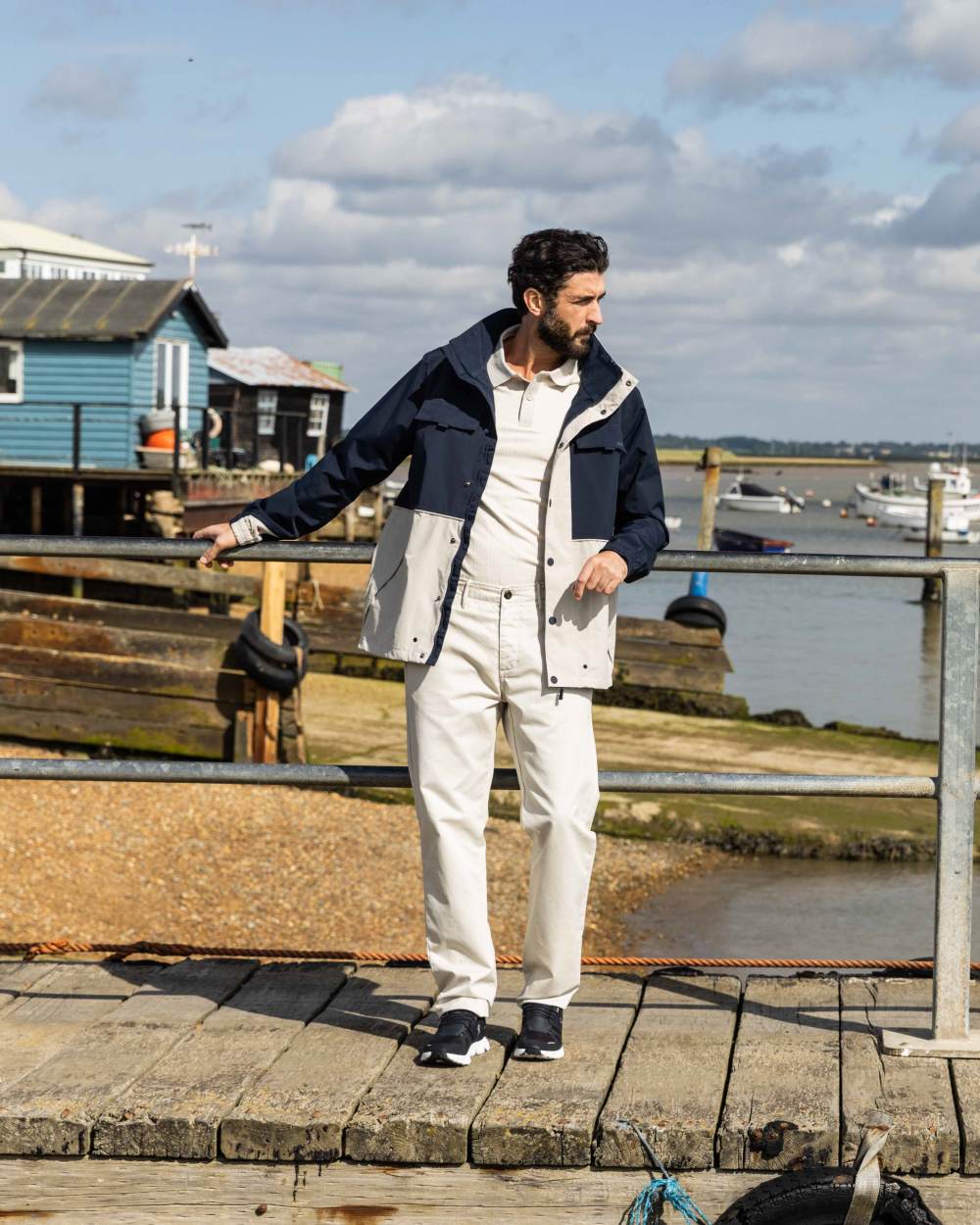 Pumice/Navy Coloured Musto Mens Classic Shore Waterproof Jacket On A Coastal Background 