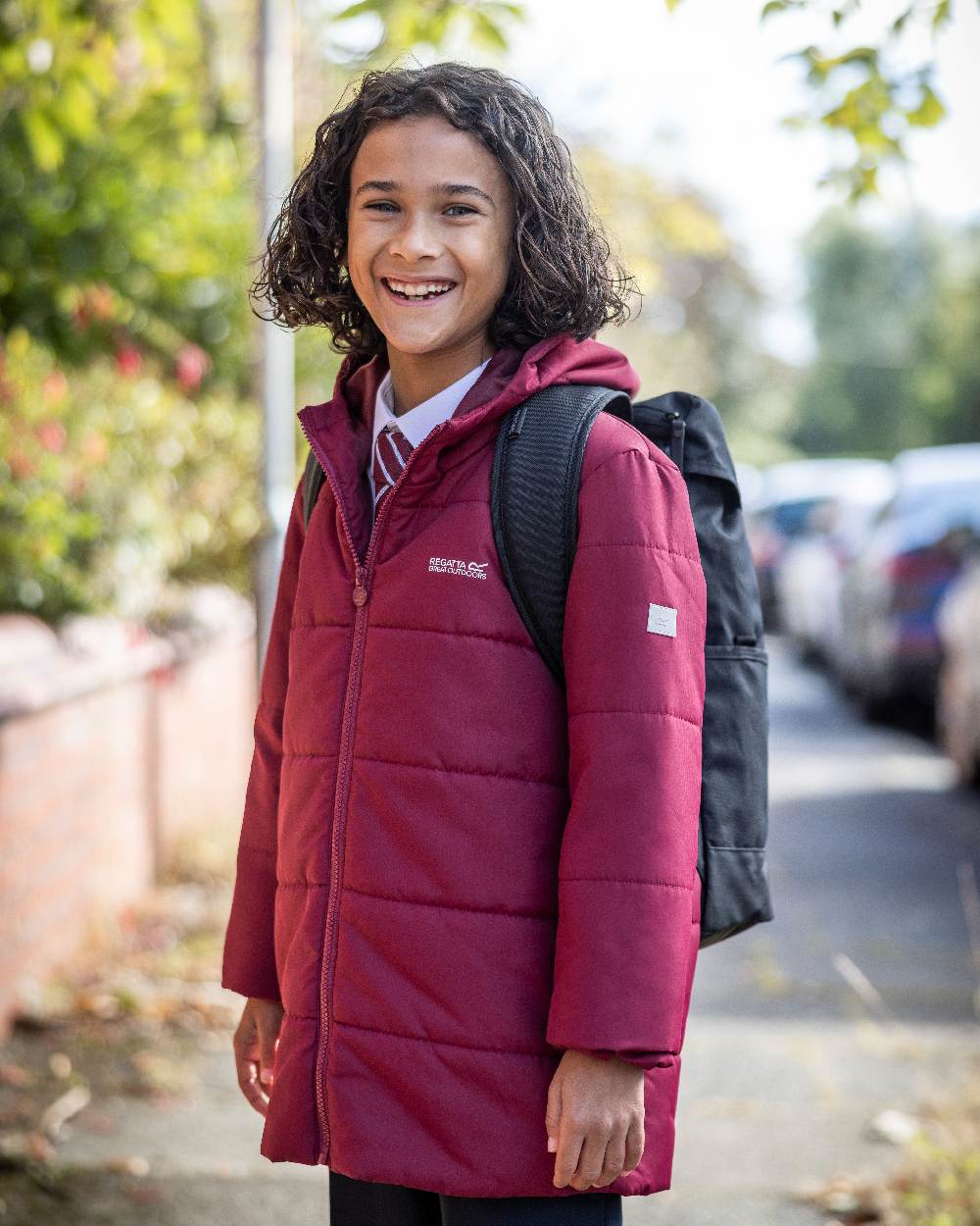 Dark Pimento Coloured Regatta Childrens Halkner Quilted Jacket on outdoor background 