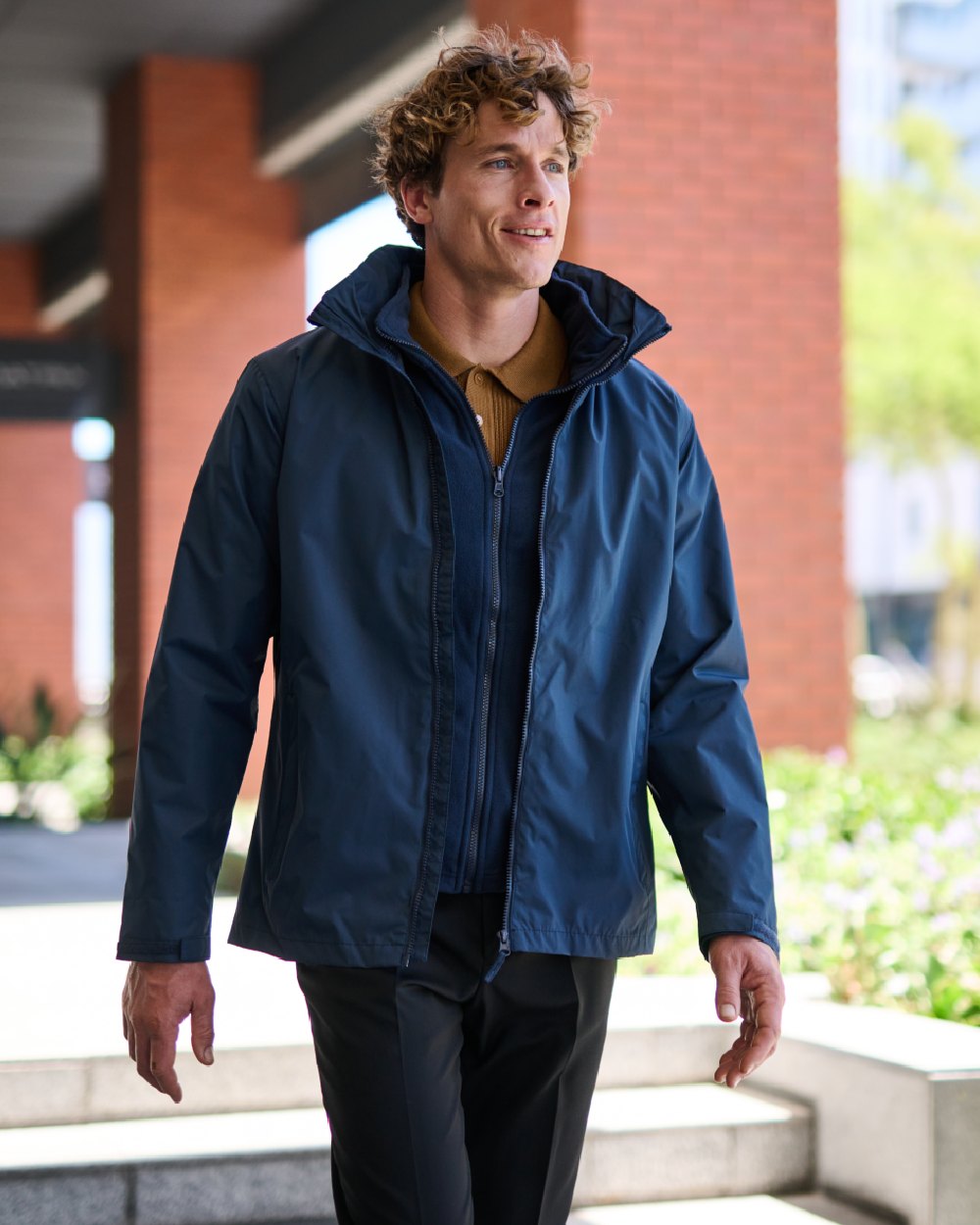 Navy coloured Regatta Mens Classic Waterproof 3 in 1 Jacket on wall background 