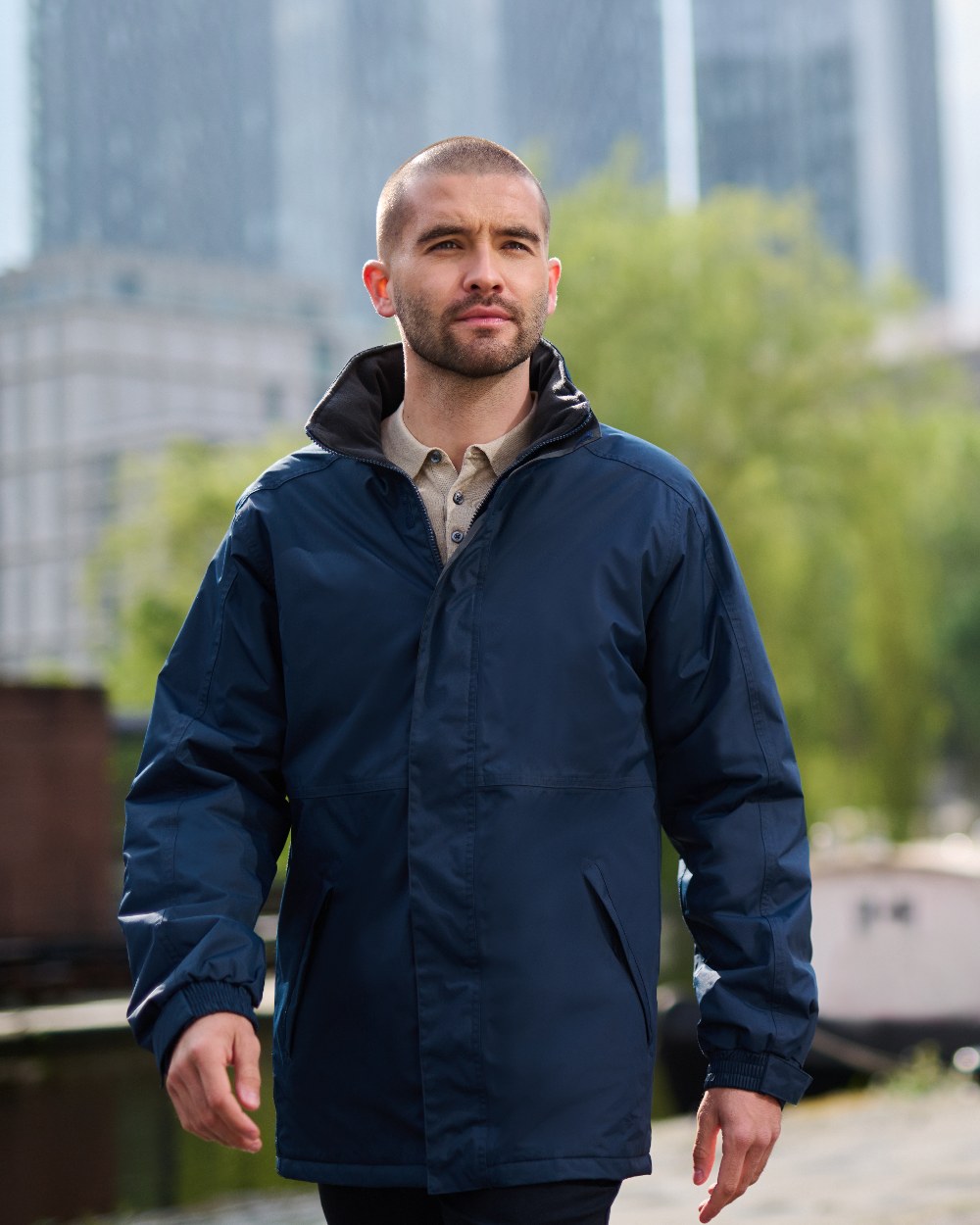 Navy coloured Regatta Mens Dover Waterproof Parka Jacket on blurry background 