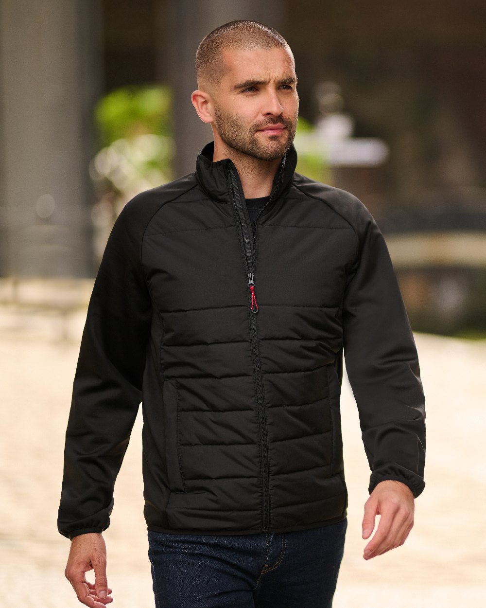 Black coloured Regatta Mens Essential Hybrid Jacket on blurry background 