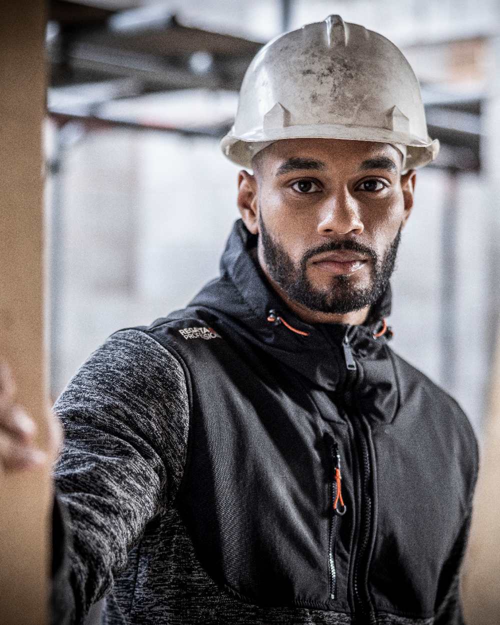 Ash Marl Black coloured Regatta Mens Heist Hybrid Jacket on blurry background 