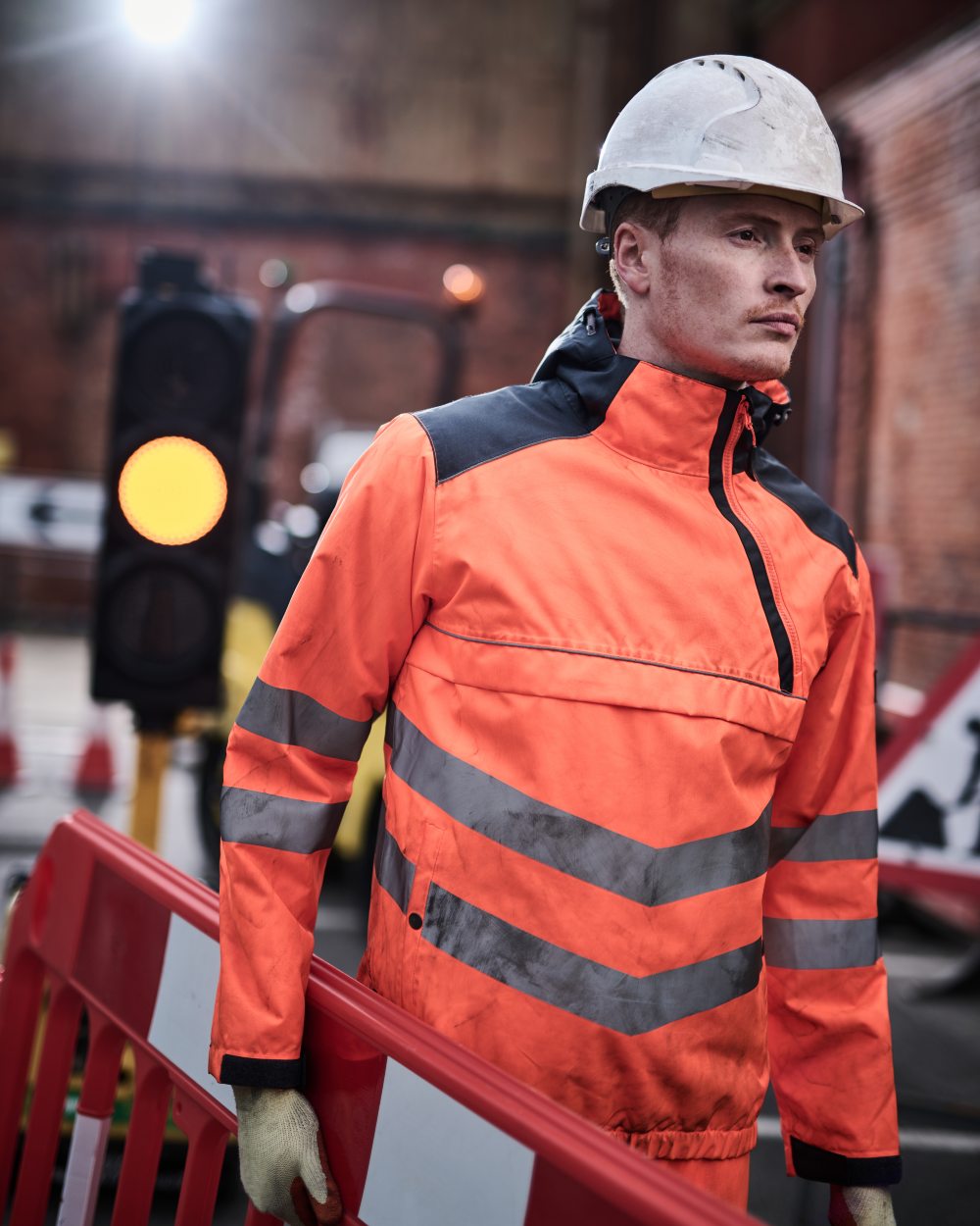 Orange Grey coloured Regatta Mens Hi-Vis Waterproof Insulated Reflective Overhead Bomber Jacket on blurry background 