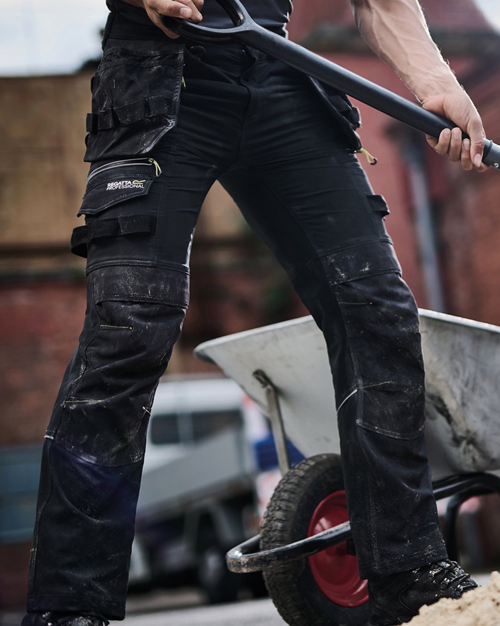 Black coloured Regatta Mens Infiltrate Softshell Stretch Trousers on blurry background 