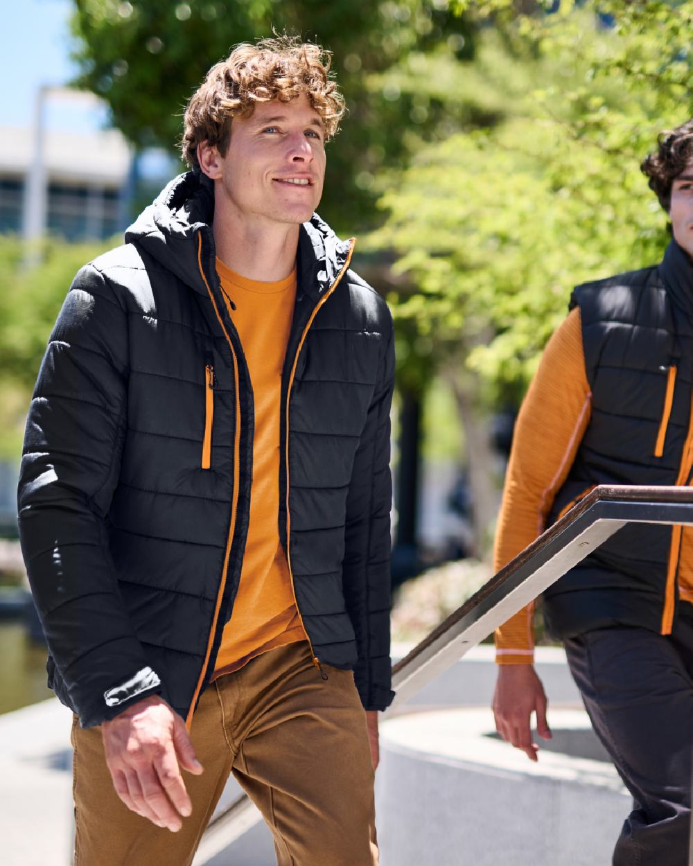 Black Orange Pop coloured Regatta Mens Navigate Thermal Bodywarmer on blurry background 