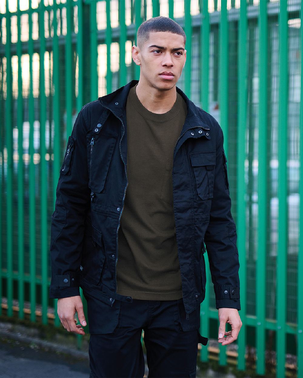 Black Coloured Regatta Mens Pro Utility Jacket on Green Gate background 