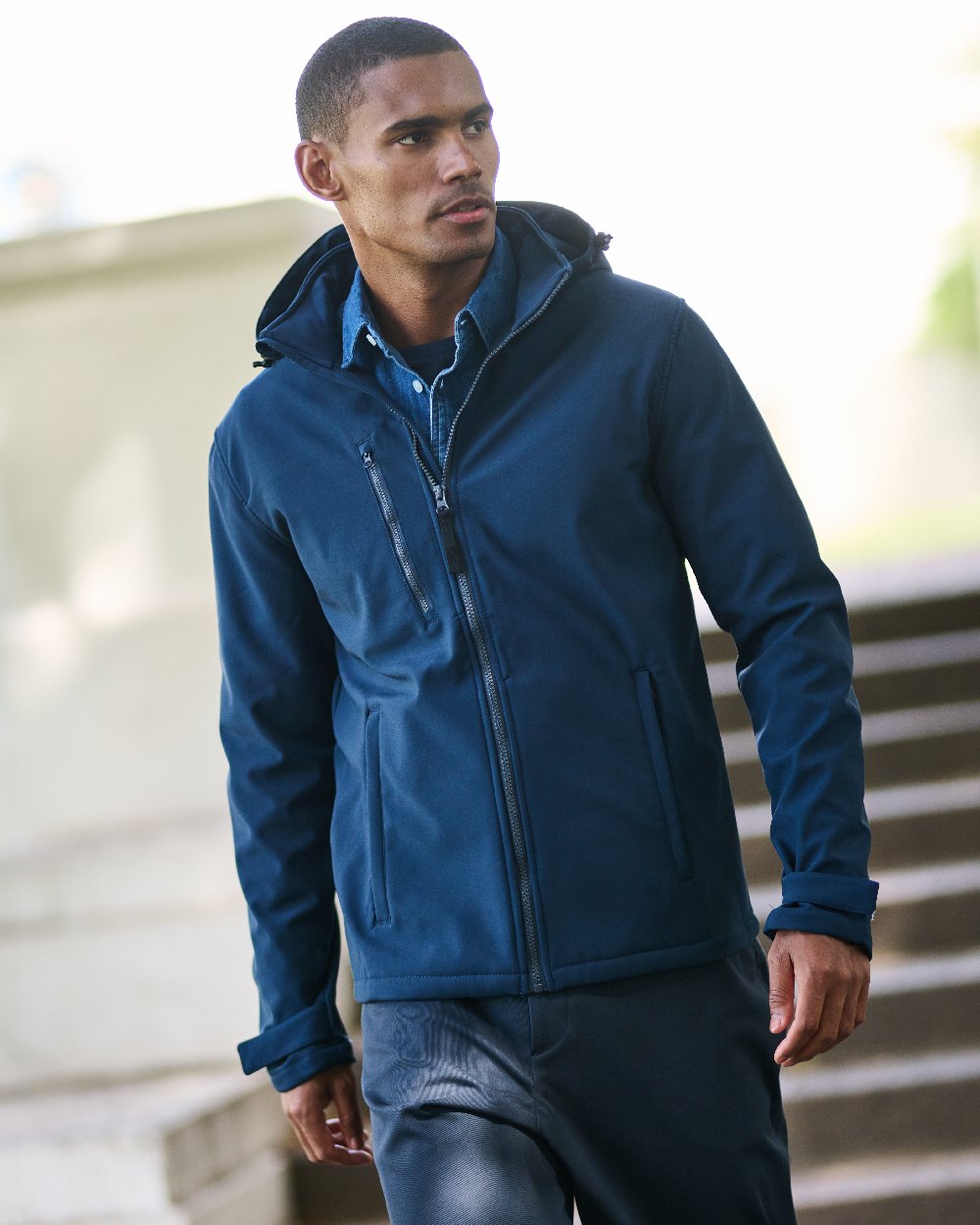 Navy coloured Regatta Mens Venturer 3 Layer Printable Hooded Softshell Jacket on blurry background 