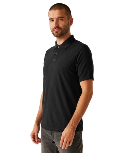 Black coloured Regatta Professional Mens 65/35 Short Sleeves Polo Top on white background 