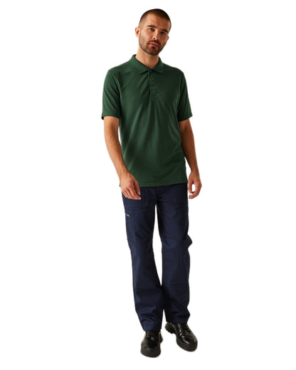 Dark Green coloured Regatta Professional Mens 65/35 Short Sleeves Polo Top on white background 