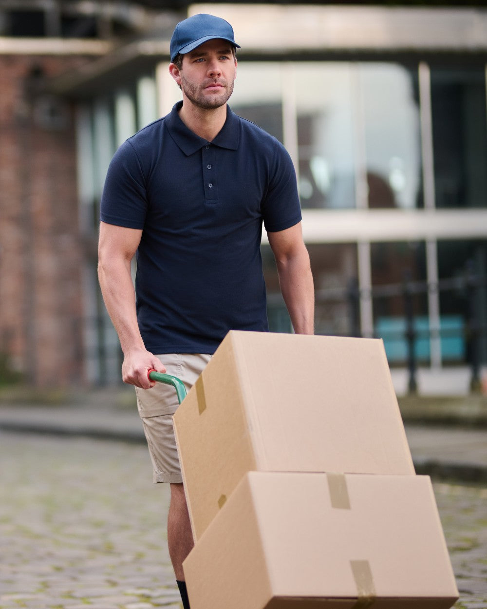 Navy coloured Regatta Professional Mens 65/35 Short Sleeves Polo Top on outdoor background 