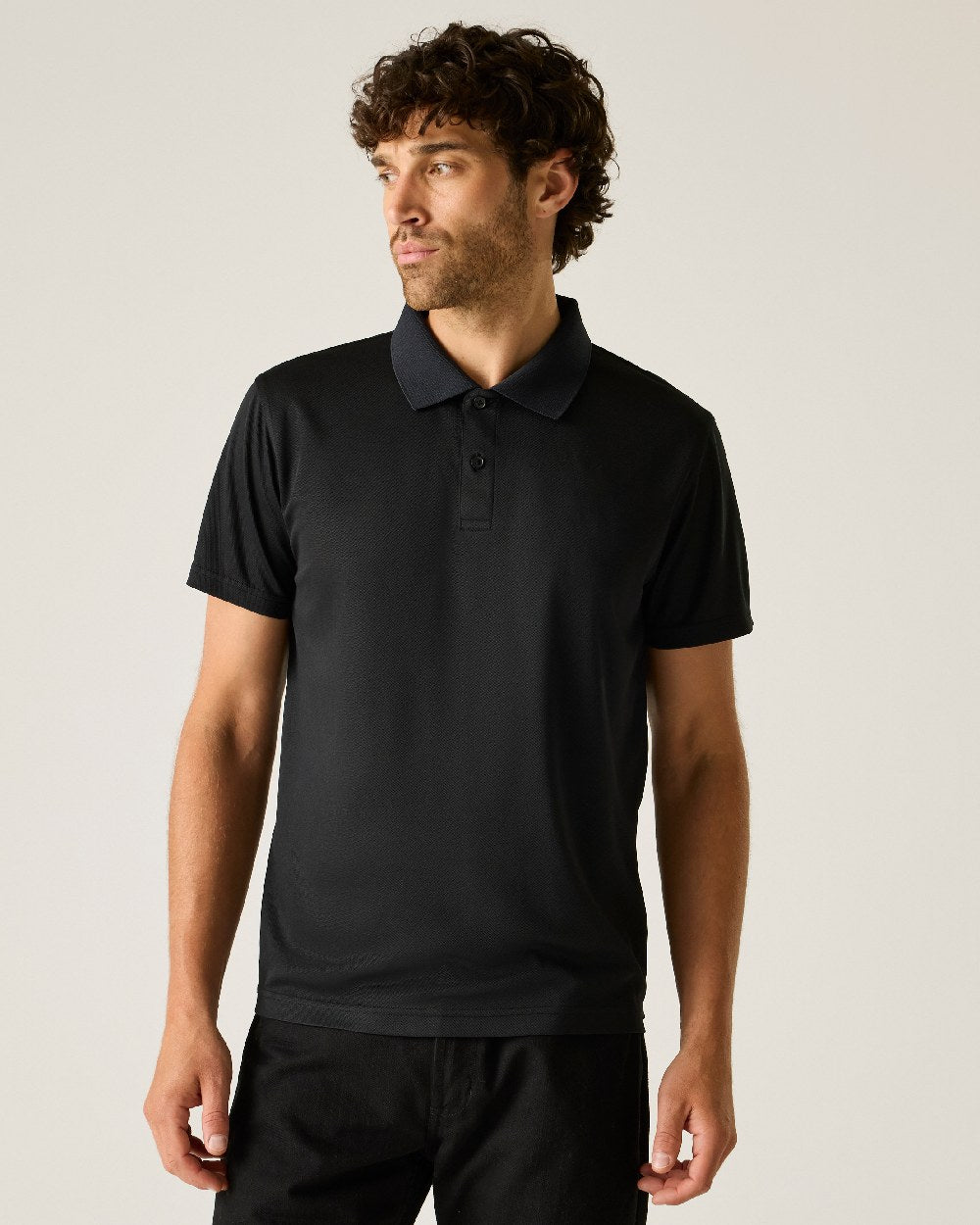 Black colour Regatta Professional Mens Pro Wicking Pique Polo Shirt on beige background 