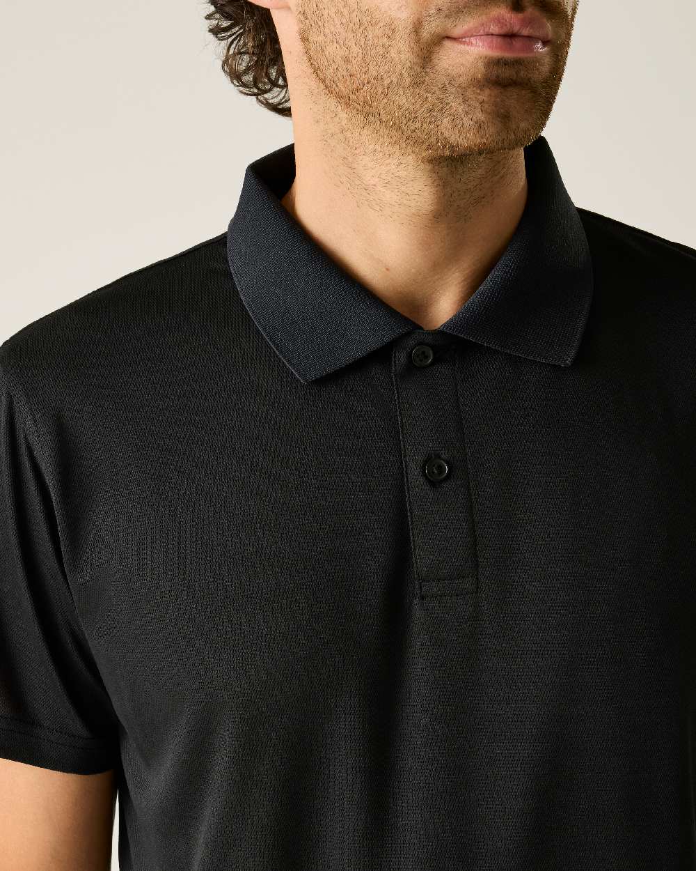 Black colour Regatta Professional Mens Pro Wicking Pique Polo Shirt on beige background 