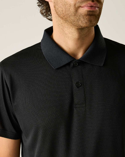 Black colour Regatta Professional Mens Pro Wicking Pique Polo Shirt on beige background 