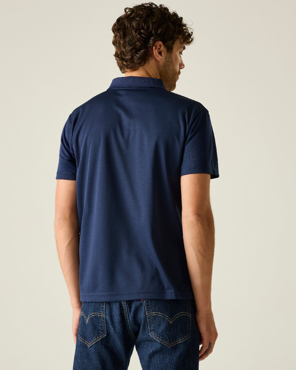 Navy colour Regatta Professional Mens Pro Wicking Pique Polo Shirt on beige background 