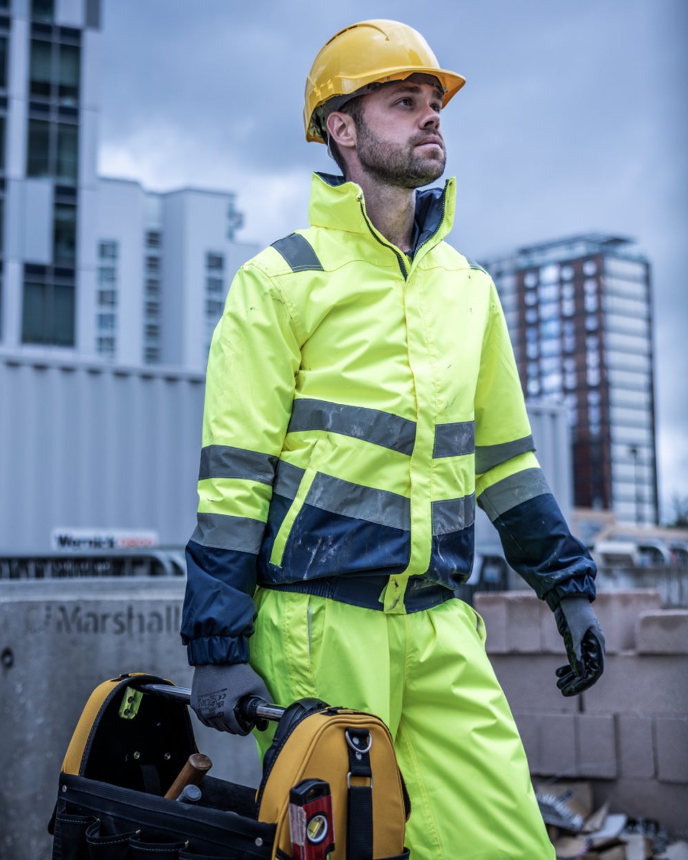 Yellow Navy coloured Regatta Professional Mens Waterproof Hi-Vis Bomber Jacket on outdoor background 