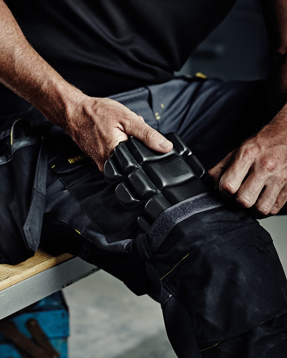 Black coloured Regatta Safety Knee Pad on blurry background