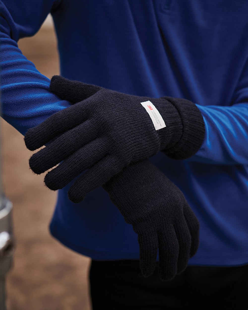 Navy coloured Regatta Thinsulate Acrylic Gloves on blurry background 