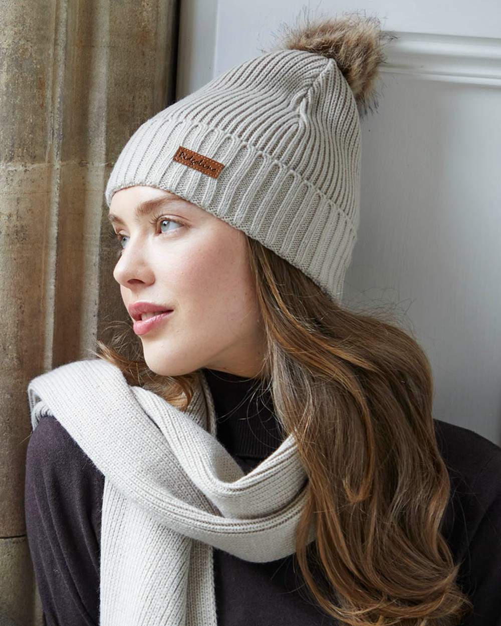 Sand coloured Ridgeline Baltic Bobble Hat &amp; Scarf Set on indoor background 