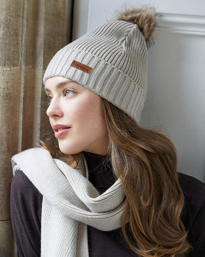 Sand coloured Ridgeline Baltic Bobble Hat &amp; Scarf Set on indoor background 