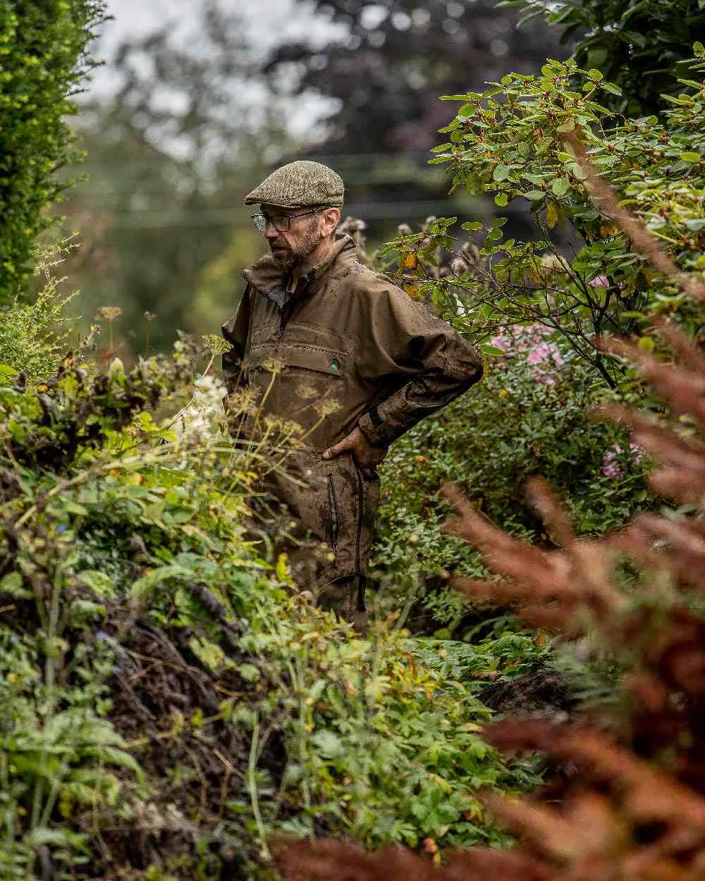 Heather Brown coloured Ridgeline Evolution Waterproof Smock on blurry trees background 