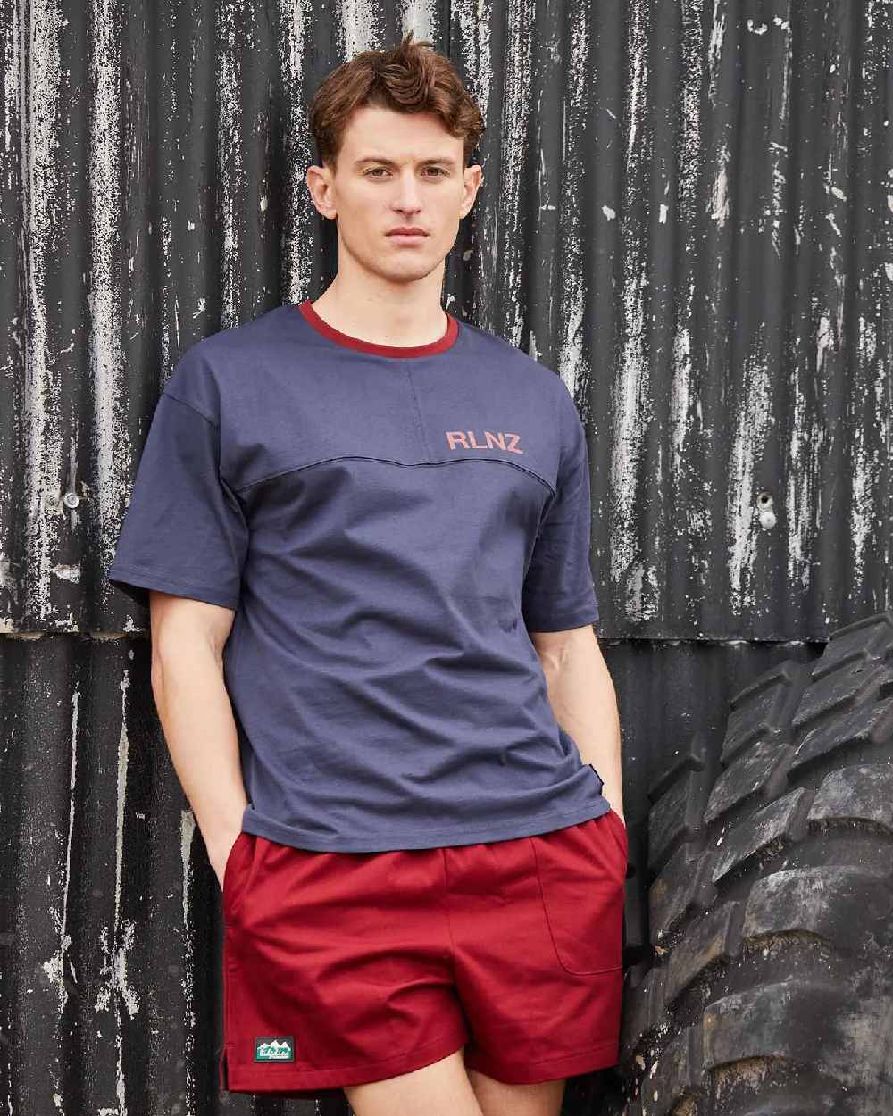 Rhubarb coloured Ridgeline Hose Down Shorts on black wall background 