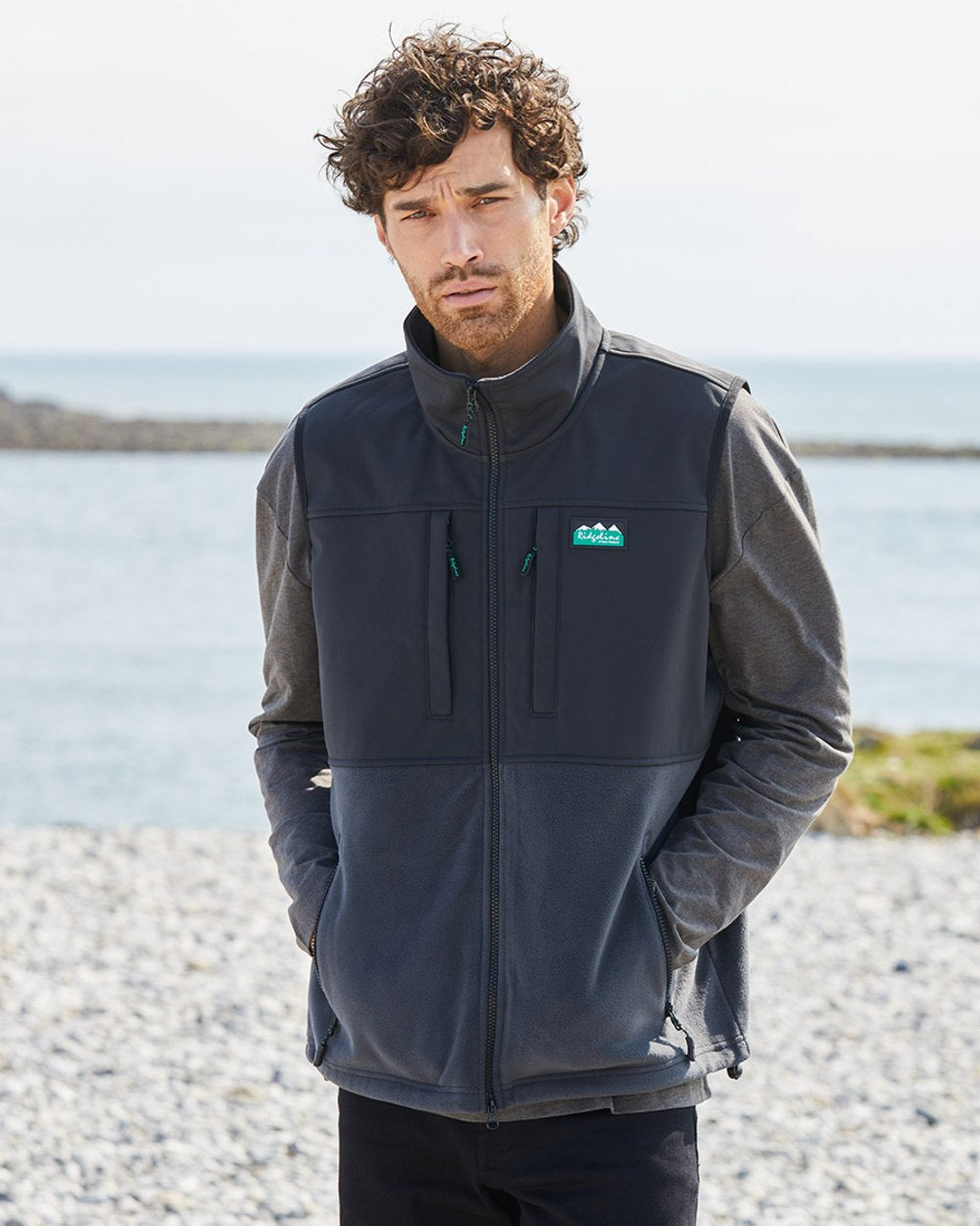 Shale coloured Ridgeline Hybrid Fleece Gilet on sea background 