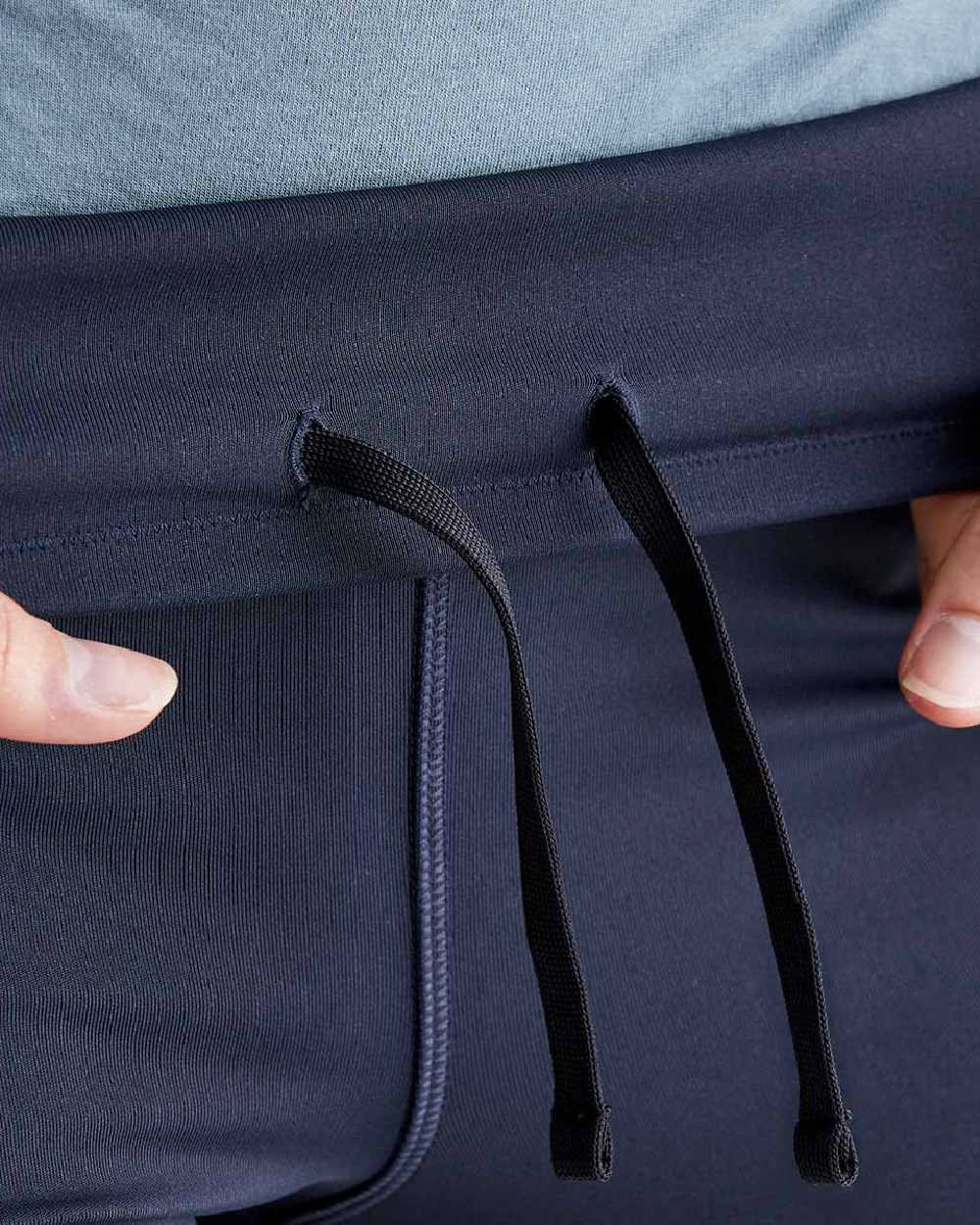 Navy coloured Ridgeline Infinity Pro Leggings on grey background 