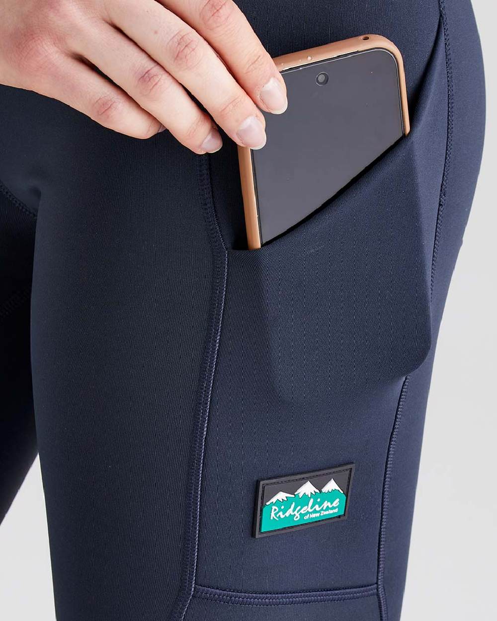 Navy coloured Ridgeline Infinity Pro Leggings on grey background 
