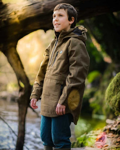 Teak coloured Ridgeline Kids Monsoon Smock on forest background 