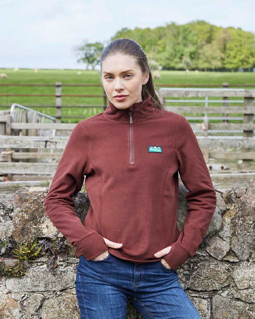 Oxblood coloured Ridgeline Ladies Narvik Fleece on farm background 