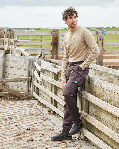 Deep Bark coloured Ridgeline Mens Grafter Trousers on farm background 