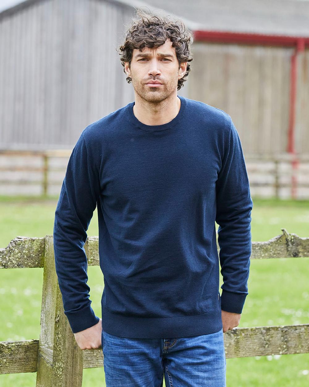 Navy coloured Ridgeline Mens Hartland Crew Knit Jumper on farm background 