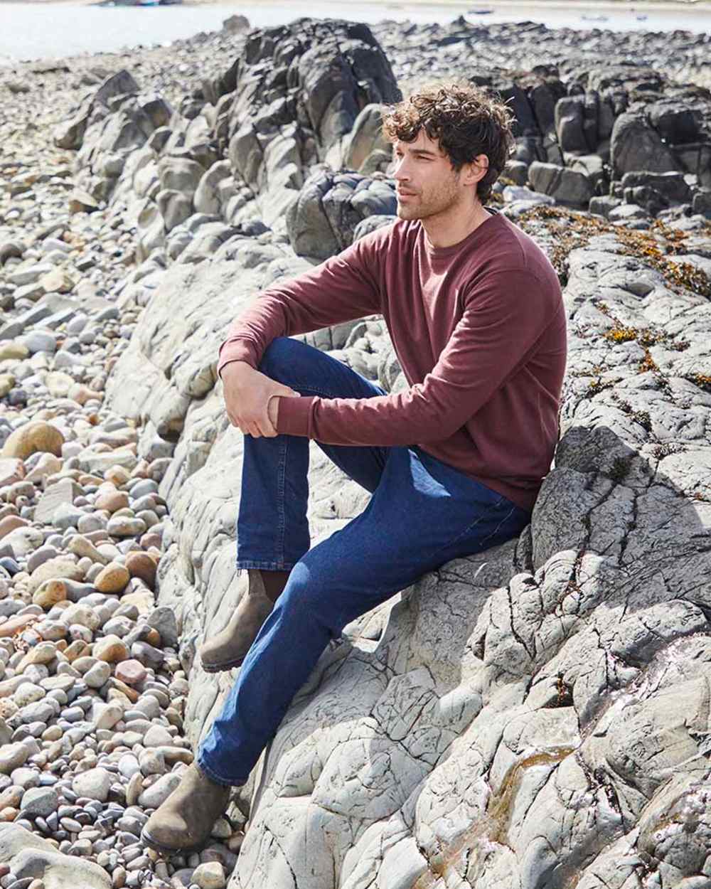 Oxblood coloured Ridgeline Mens Hartland Crew Knit Jumper on shore background 