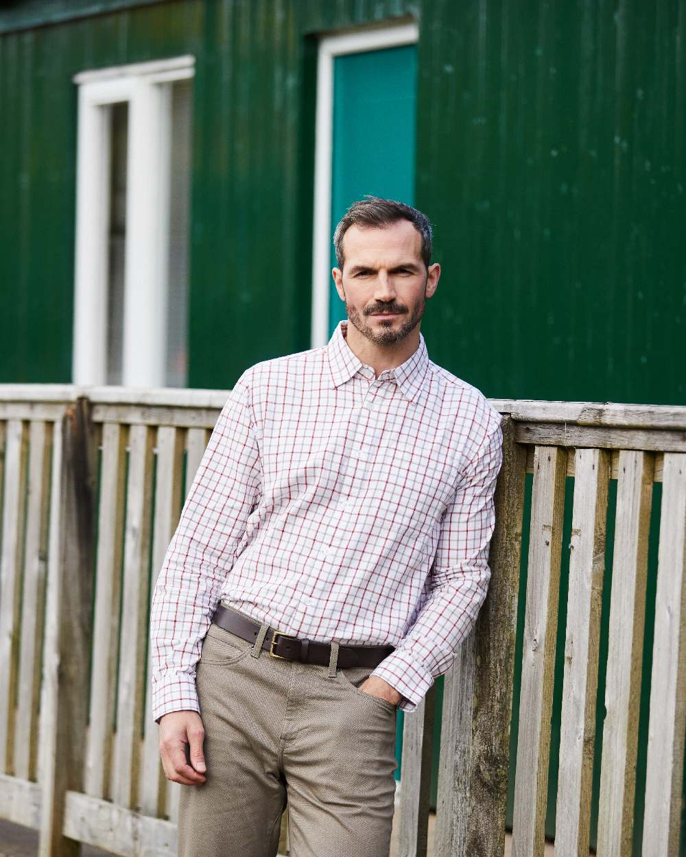 Russet coloured Ridgeline Mens Sedgebrook Shirt on house background 