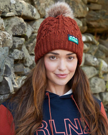 Russet Coloured Ridgeline Nordic Fleck Bobble Hat on outdoor background 