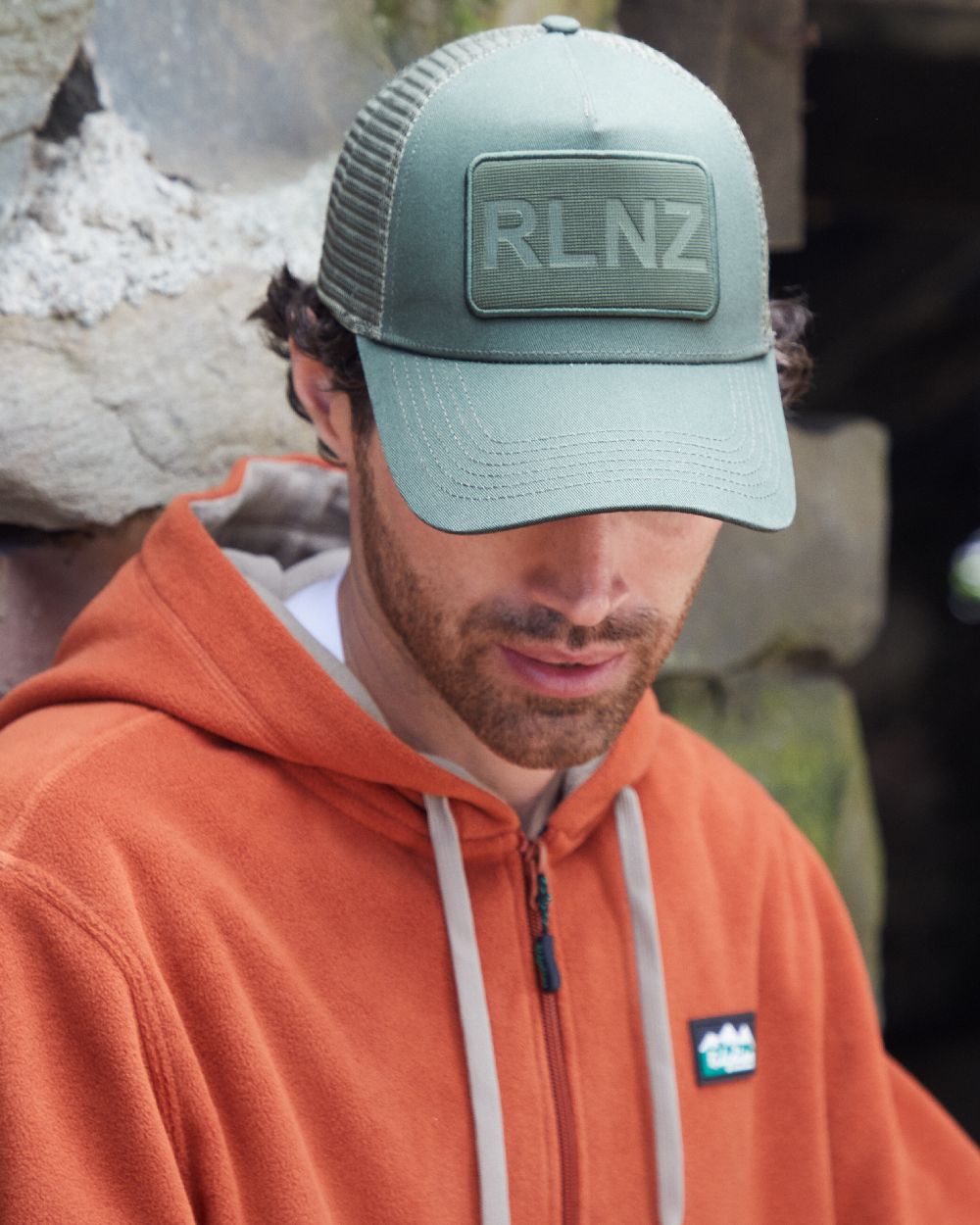 Olive Coloured Ridgeline RLNZ Trucker Cap on outdoor background 