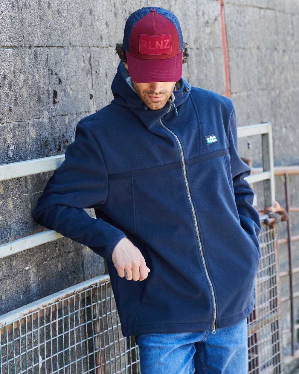 Rhubarb Coloured Ridgeline RLNZ Trucker Cap on outdoor background 