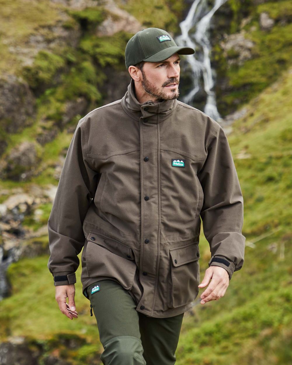 Bark coloured Ridgeline Torrent III Waterproof Jacket on blurry mountain background 