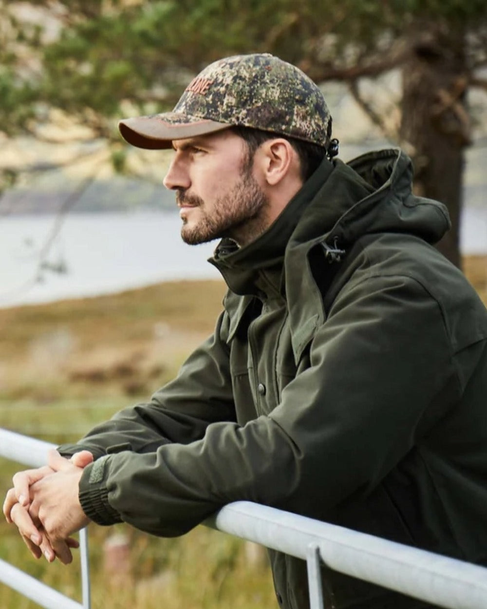 Olive coloured Ridgeline Torrent III Waterproof Jacket on blurry background 